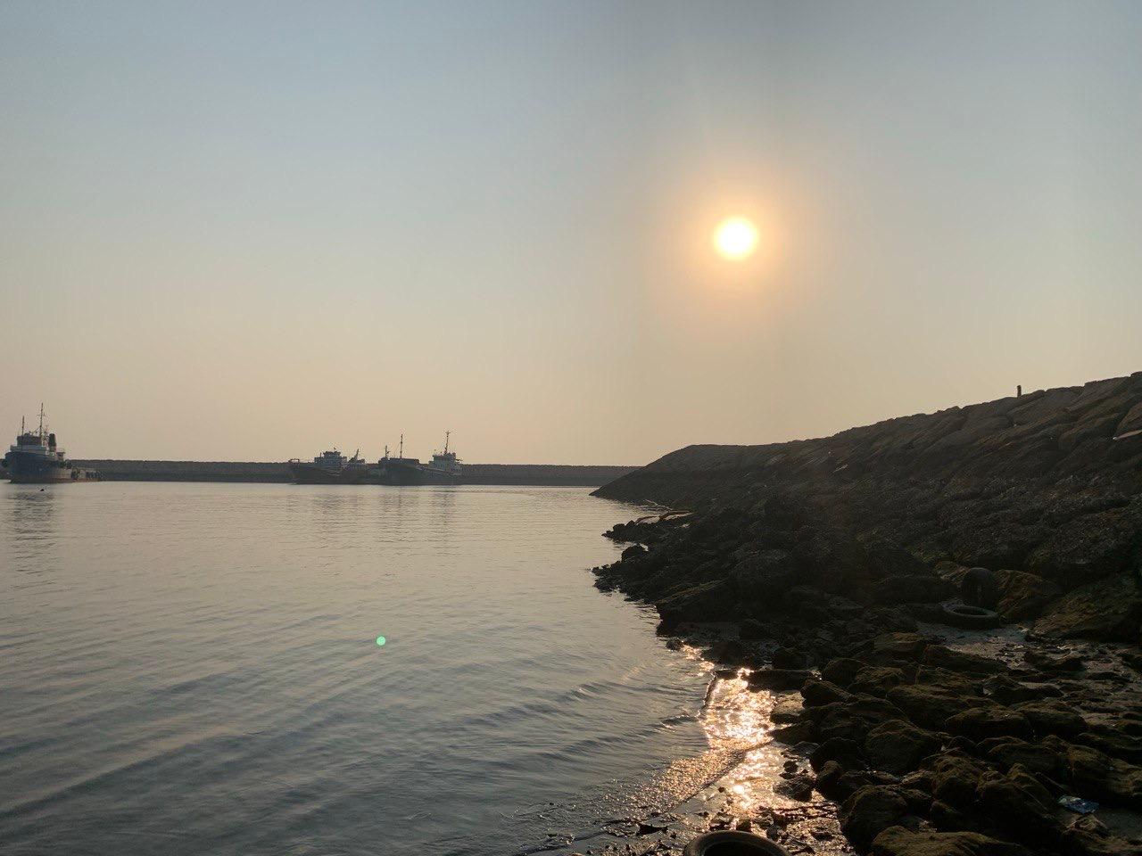 Soleil voilé au-dessus d'un port